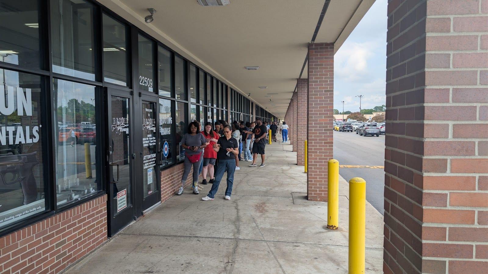 Women waiting along the storefront windows outside the range entrance