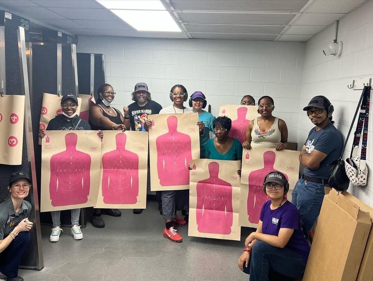 A group of attendees proudly holding up their first targets