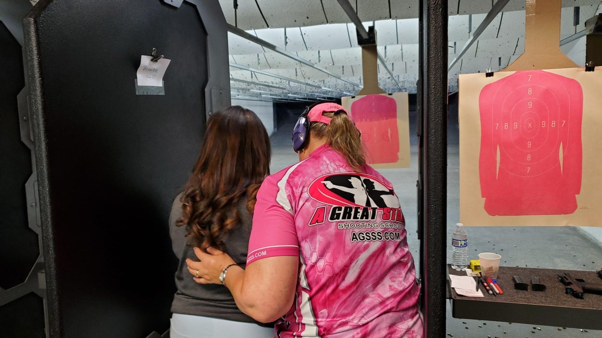 A volunteer instructor coaching a first-time shooter on the range at last year's event