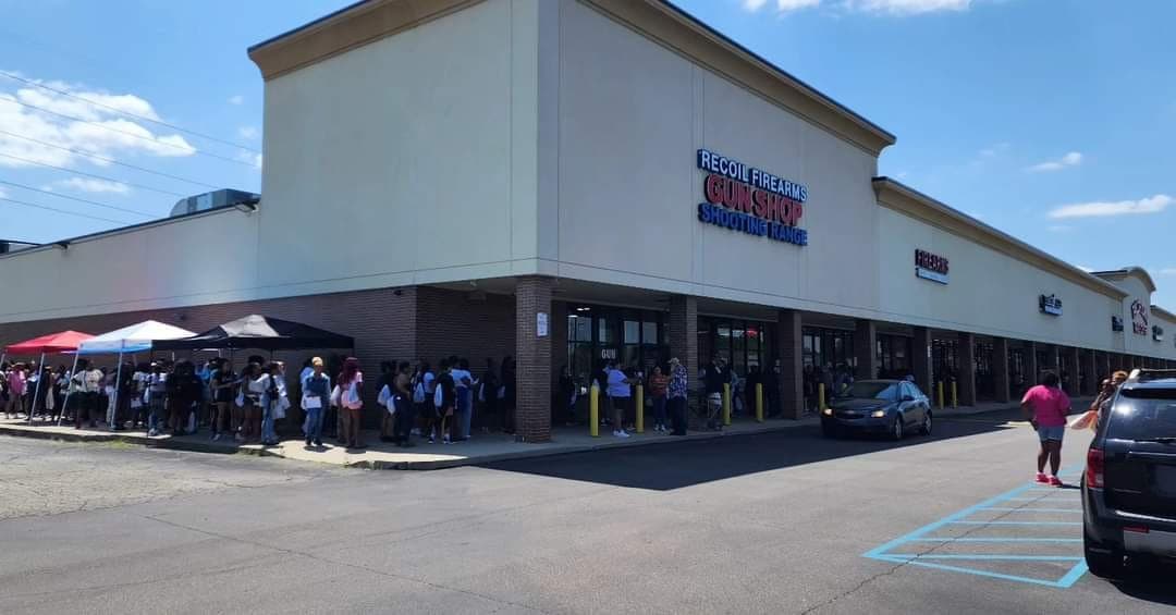 Women lined up around the Recoil Firearms building waiting for their session