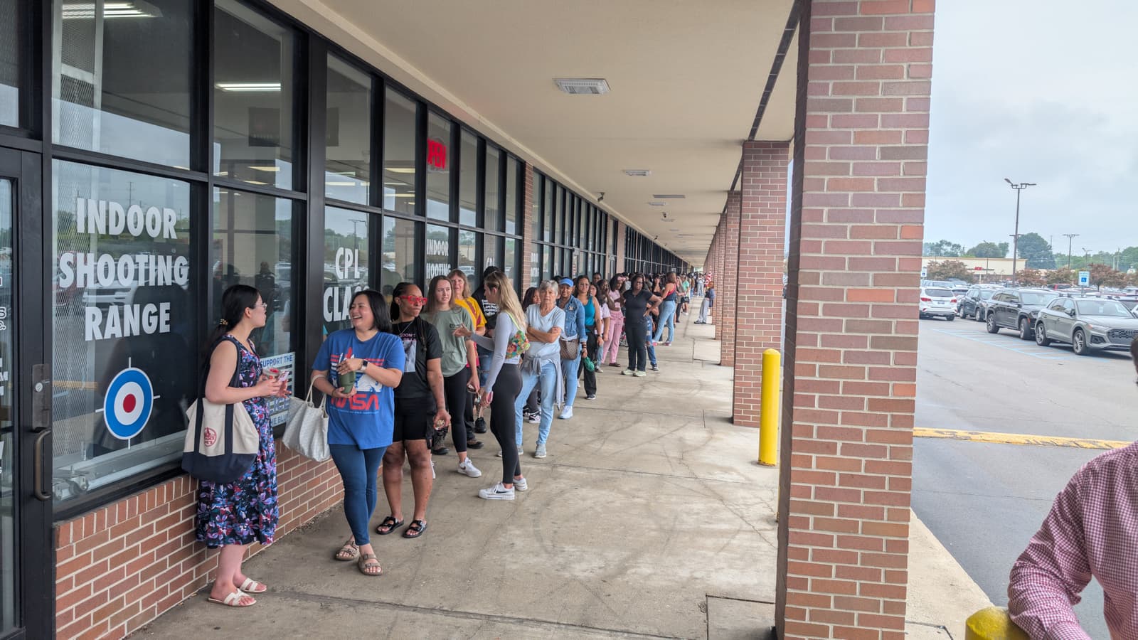 Women lined up along the Recoil Firearms storefront on event morning