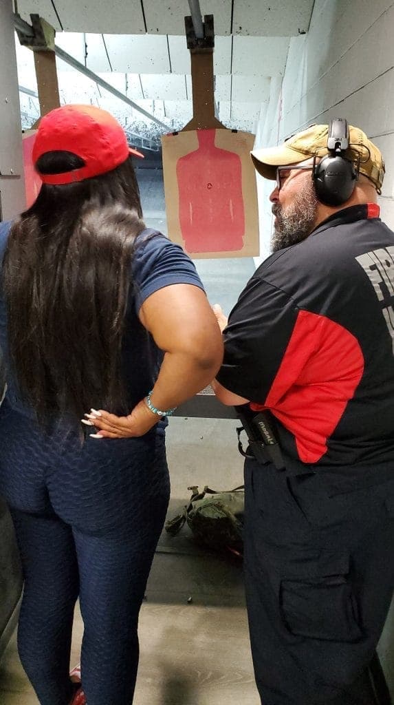 An instructor coaching a woman at her lane during the event